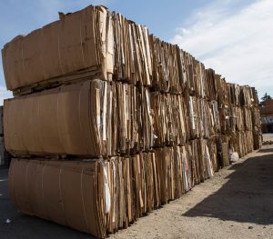 Large bundles of cardboard ready for recycling.