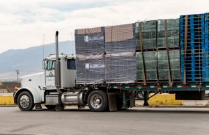 18-wheeler truck loaded with packaging supples driving off.