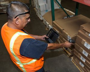 Worker scanning boxes.